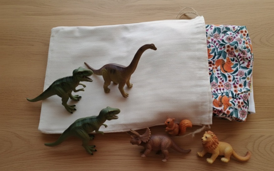 Lot de 6 calots de bloc pédiatriques pliés et présentés dans leur pochon de rangement en tissu beige, création Les Coutures de Miette.