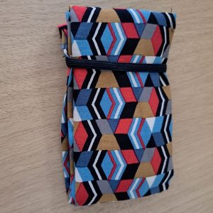 Sac de courses style Shupatto en viscose aux motifs géométriques colorés, posé à plat sur une table en bois.